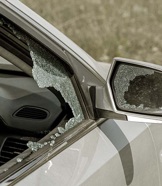 Criminal incident. Hacking a car. Broken driver's side window of car. Thieves smashed window of car with fragments inside, glass was scattered throughout. Crime - broken window and theft belongings